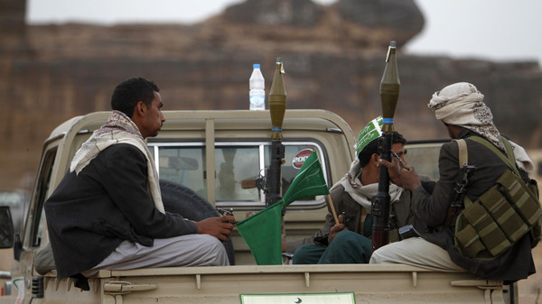 Armed followers of Yemen's Shi'ite Houthi group sit on a truck in Dhahian