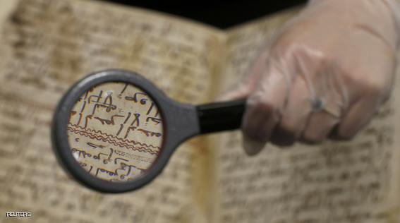 A detail of a fragment of a Koran manuscript is seen through a magnifying glass in the library at the University of Birmingham in Britain July 22, 2015. A British university said on Wednesday that fragments of a Koran manuscript found in its library were from one of the oldest surviving copies of the Islamic text in the world, possibly written by someone who might have known Prophet Mohammad. Radiocarbon dating indicated that the parchment folios held by the University of Birmingham in central England were at least 1,370 years old, which would make them one of the earliest written forms of the Islamic holy book in existence. REUTERS/Peter Nicholls