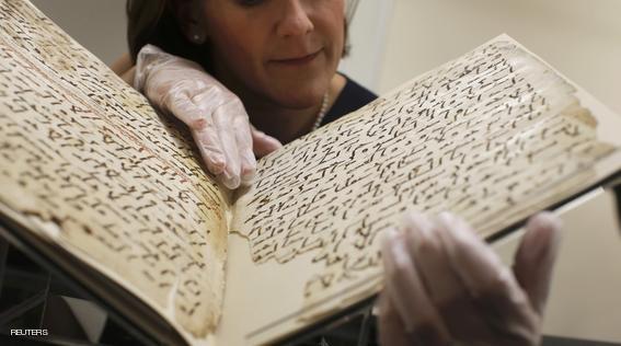 Conservator, Marie Sviergula holds a fragment of a Koran manuscript in the library at the University of Birmingham in Britain July 22, 2015. A British university said on Wednesday that fragments of a Koran manuscript found in its library were from one of the oldest surviving copies of the Islamic text in the world, possibly written by someone who might have known Prophet Mohammad. Radiocarbon dating indicated that the parchment folios held by the University of Birmingham in central England were at least 1,370 years old, which would make them one of the earliest written forms of the Islamic holy book in existence. REUTERS/Peter Nicholls