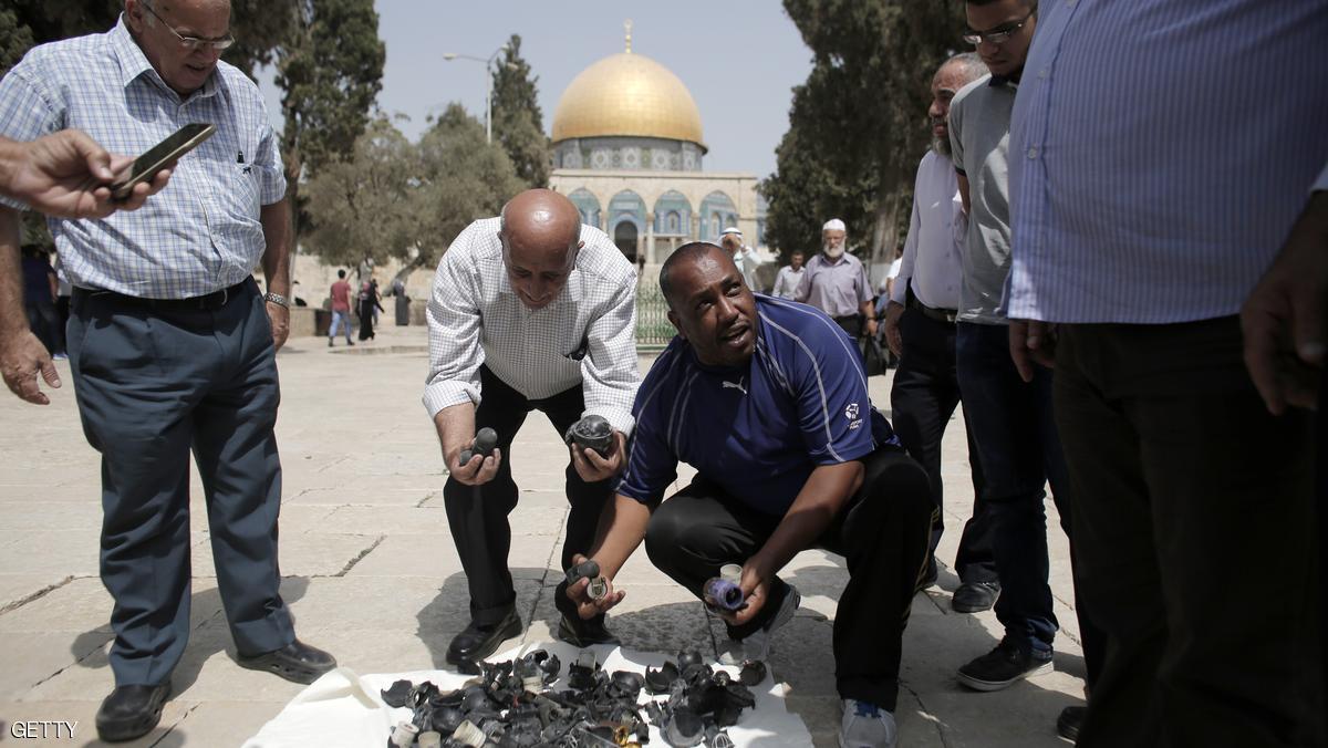 Palestinians collect rubber bullets and stun grenades reportedly used by Israeli riot police outside the Dome of Rock at Al-Aqsa mosque in Jerusalem's Old City after clashes erupted at the compound between Palestinians and Israeli police on September 13, 2015, just hours before the start of the Jewish New Year. The disturbances came with tensions running high after Israeli Defence Minister Moshe Yaalon last week outlawed the Murabitat (for females) and Murabitun groups which are made up of east Jerusalem Palestinians and Israeli Arabs and who confront Jewish visitors to the volatile Al-Aqsa mosque complex, considered Islam's third holiest shrine. AFP PHOTO / AHMAD GHARABLI (Photo credit should read AHMAD GHARABLI/AFP/Getty Images)