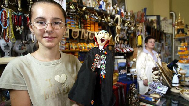 A shop vendor shows a Dracula doll in a souvenirs shop 26 July 2003, on the second day of the Medieval Art Festival in Sighisoara, some 300 km from Bucharest. Thousands of people came to the medieval fortress of Sighisoara for a three-day cultural event which gathers craftsmen, musicians and theater performers. AFP PHOTO DANIEL MIHAILESCU (Photo by DANIEL MIHAILESCU / AFP)